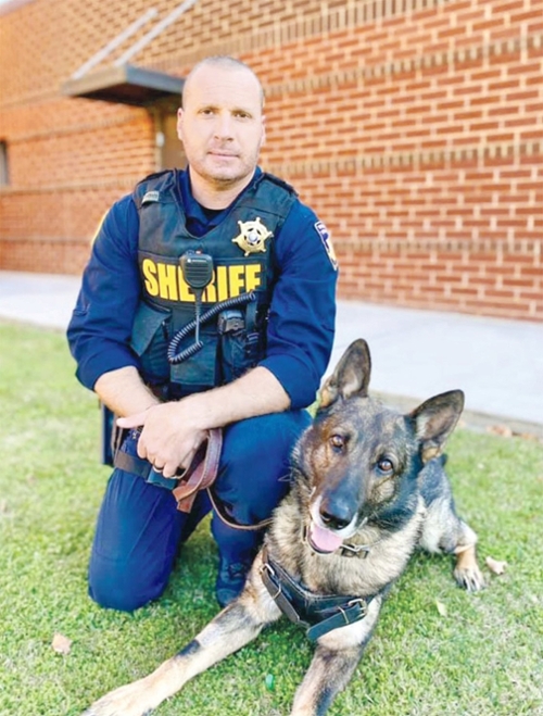K-9 JOKER poses with his partner BCSO Deputy Eduardo Choate prior to being shot by burglars in September. CONTRIBUTED FILE PHOTO